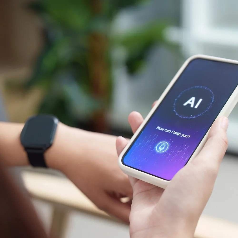 Hand holding a phone showing an AI assistant for Greenwich business use