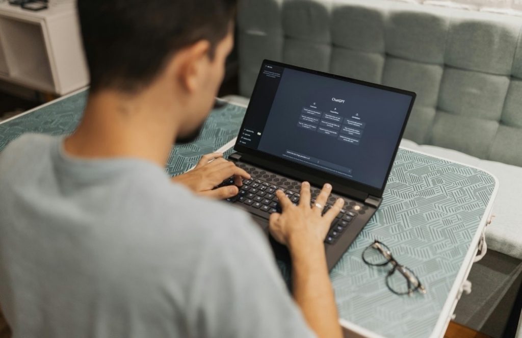 Software developer coding on a laptop