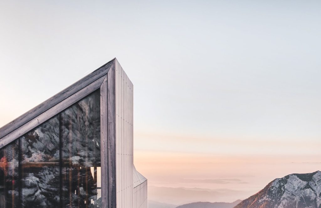 Contemporary wood-clad building beneath a sunset sky